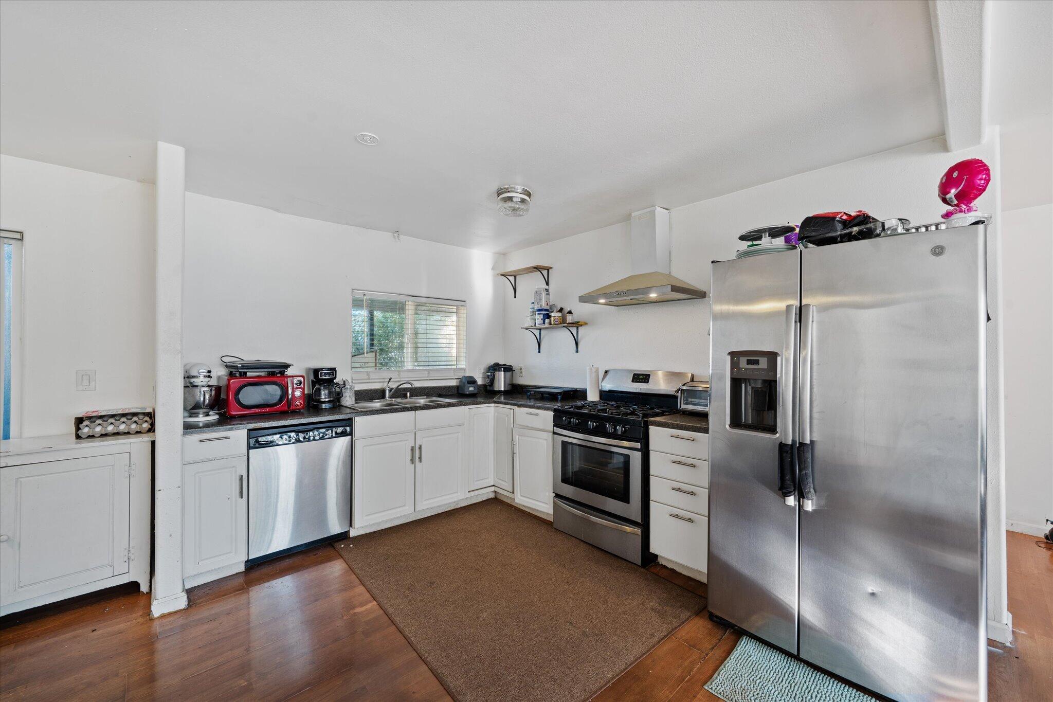 2494 Delta Place, Unit 71 Redding, CA 96002 - Photo 9 of 24 a kitchen with granite countertop a sink and stainless steel appliances