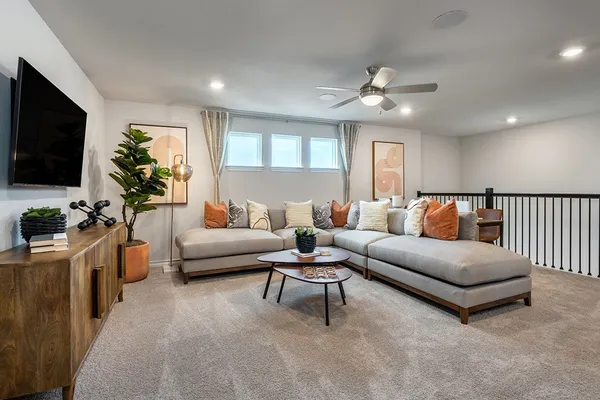 a spacious bedroom with a bed and a potted plant