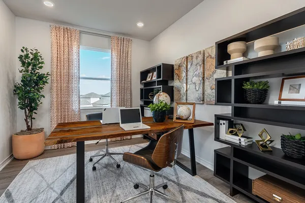 a living room with furniture kitchen view and a chandelier
