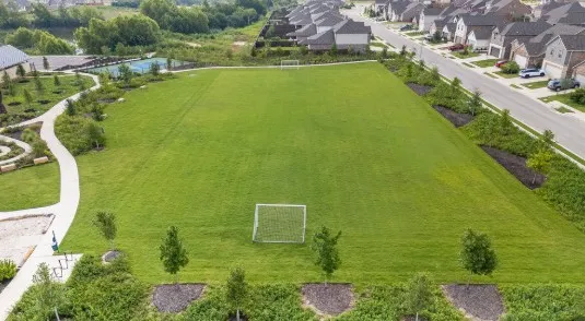 an aerial view of a house with garden space and lake view