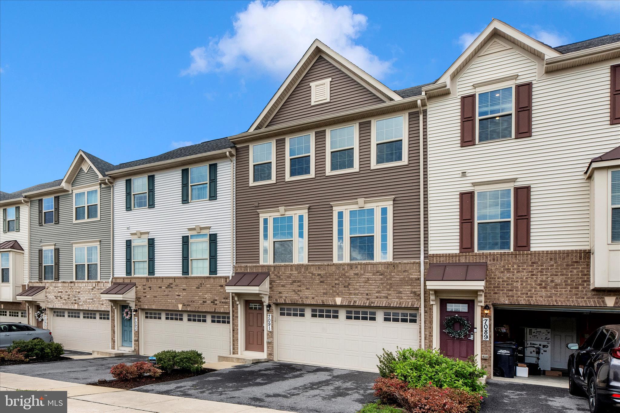 7091 Kokanee Way New Market, MD 21774 - Photo 50 of 69 a front view of a residential apartment building with a yard