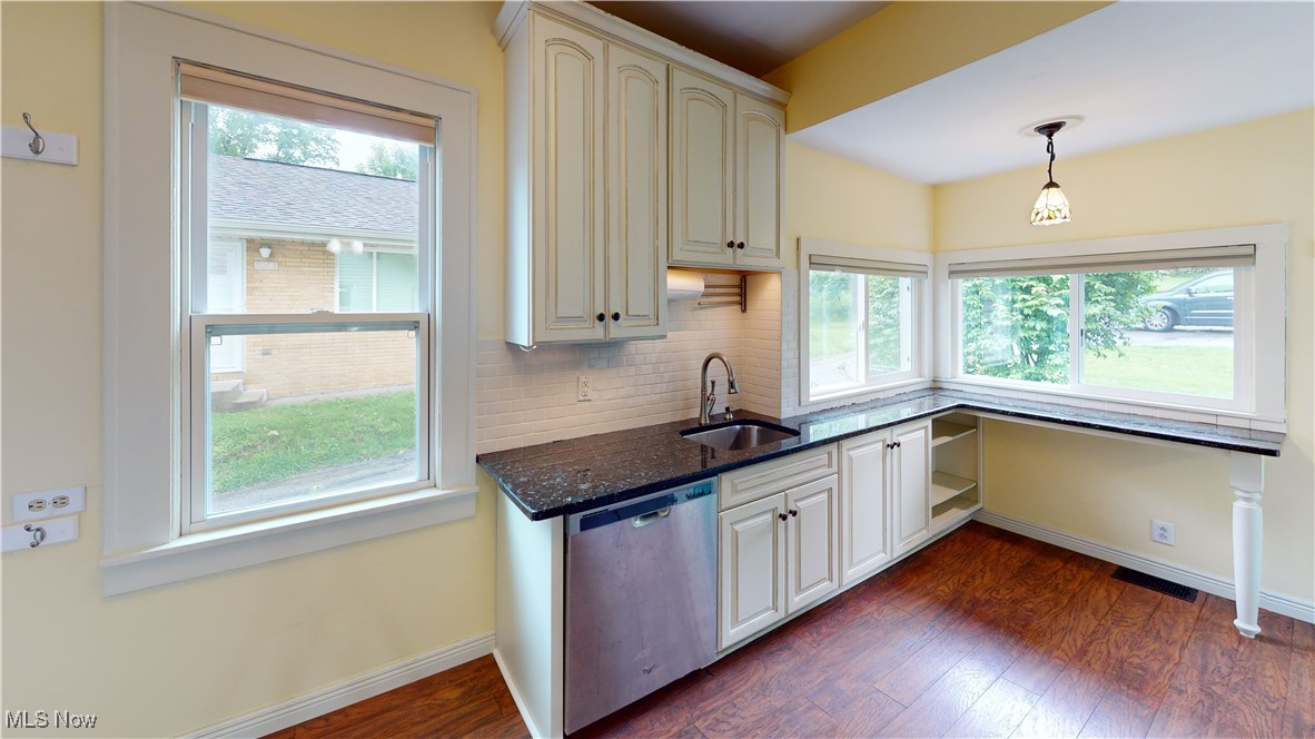 3261 Darrow Road Stow, OH 44224 - Photo 11 of 27 Kitchen with stainless steel dishwasher, a sink, healthy amount of natural light, and decorative backsplash