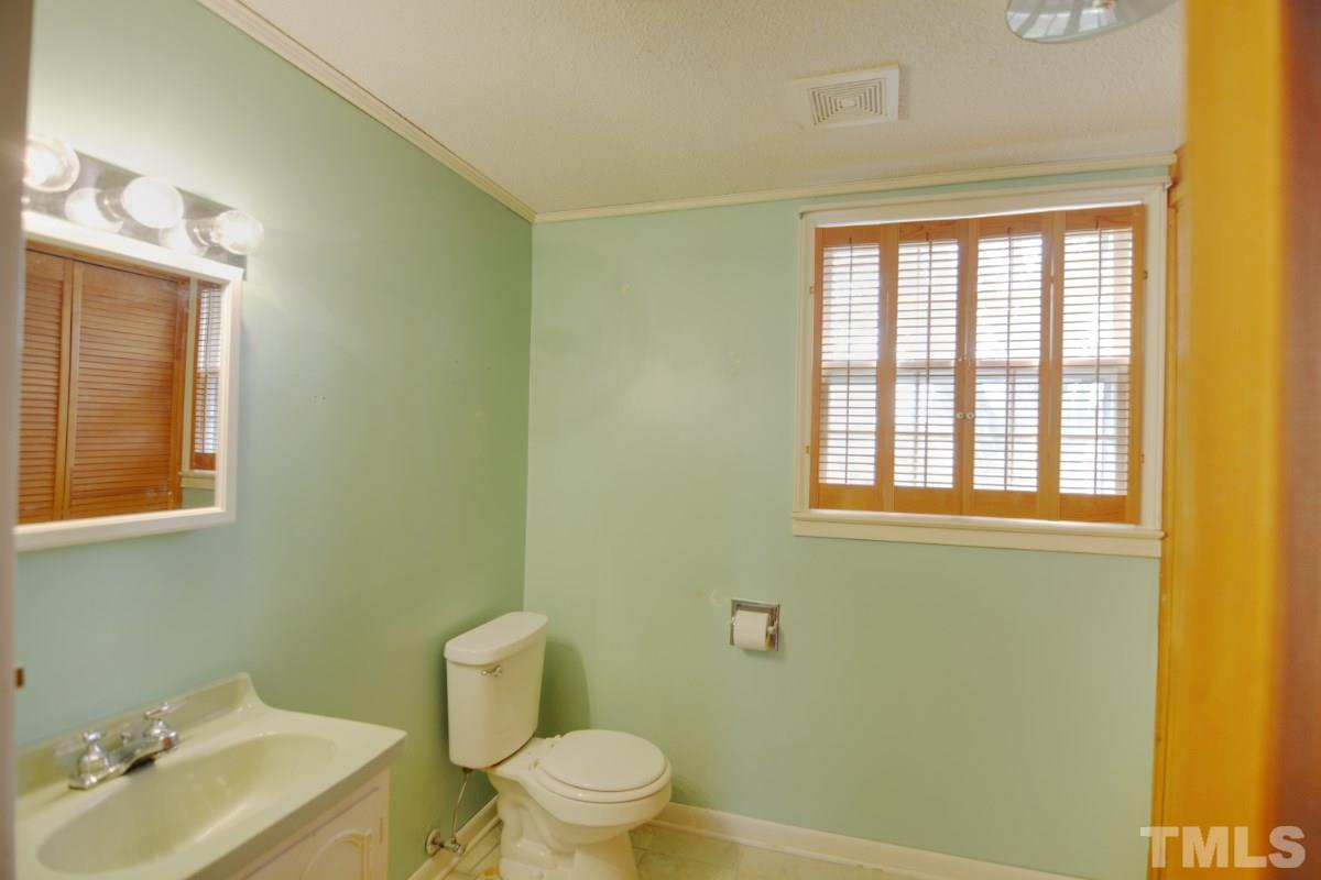 4016 Willow Oak Road Raleigh, NC 27604 - Photo 12 of 21 a bathroom with a toilet sink vanity and mirror