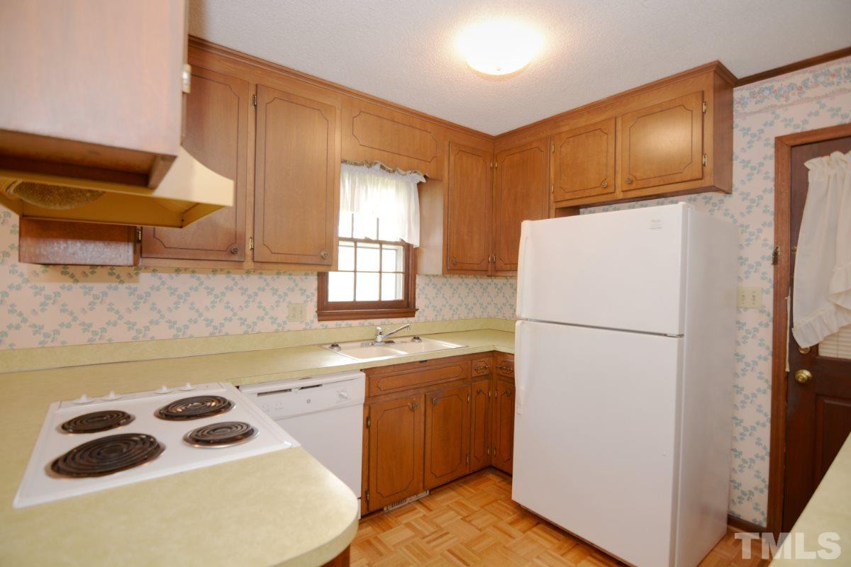 4016 Willow Oak Road Raleigh, NC 27604 - Photo 13 of 21 a kitchen with a sink a refrigerator and cabinets