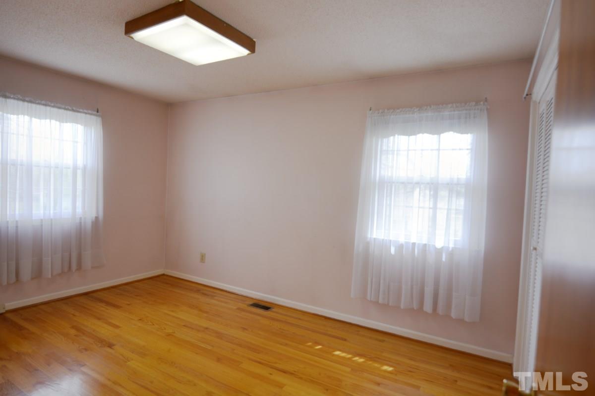 4016 Willow Oak Road Raleigh, NC 27604 - Photo 14 of 21 an empty room with wooden floor and windows