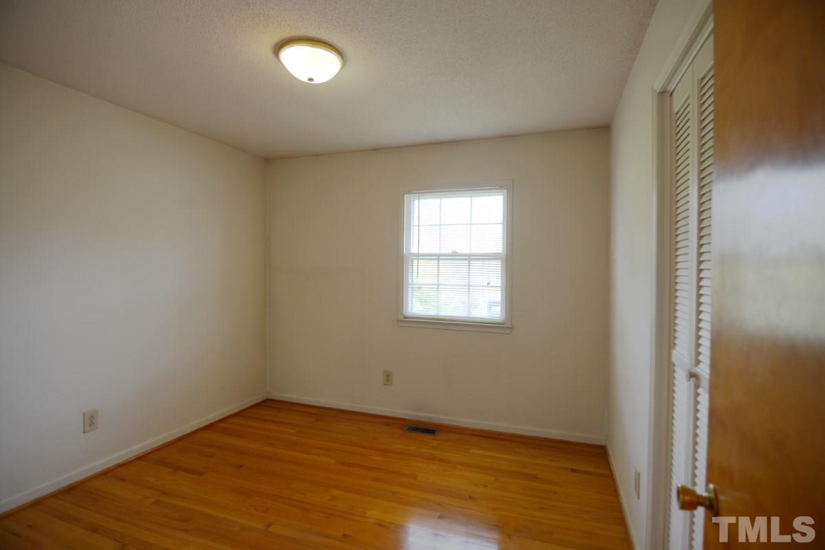 4016 Willow Oak Road Raleigh, NC 27604 - Photo 15 of 21 an empty room with wooden floor and windows
