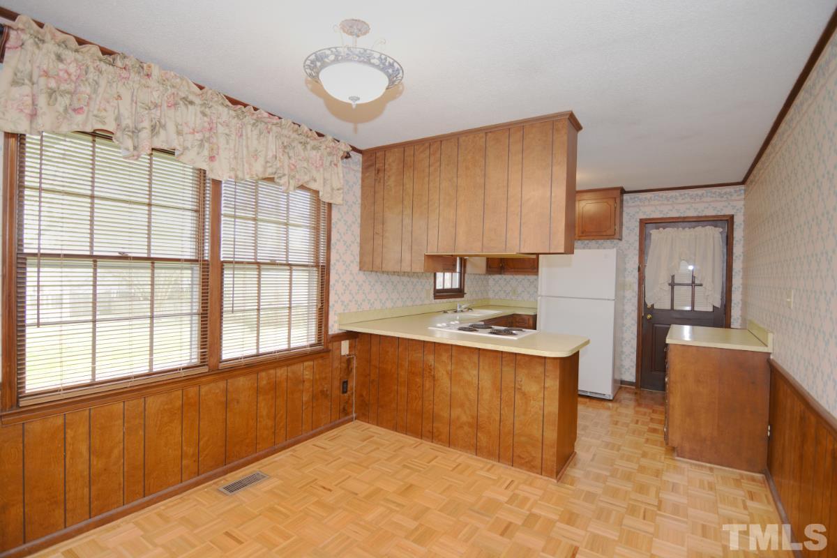 4016 Willow Oak Road Raleigh, NC 27604 - Photo 6 of 21 a kitchen with granite countertop a stove a sink dishwasher and a refrigerator