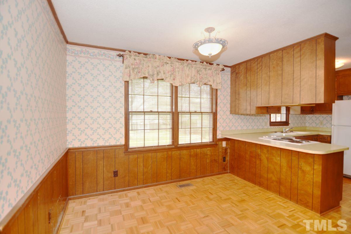4016 Willow Oak Road Raleigh, NC 27604 - Photo 7 of 21 a kitchen with a stove a sink and a refrigerator