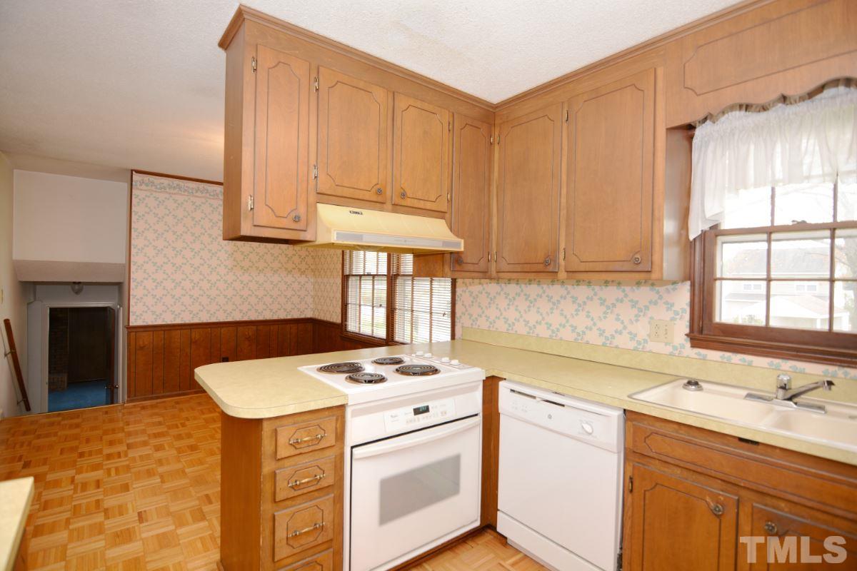 4016 Willow Oak Road Raleigh, NC 27604 - Photo 8 of 21 a kitchen with a sink stove and cabinets