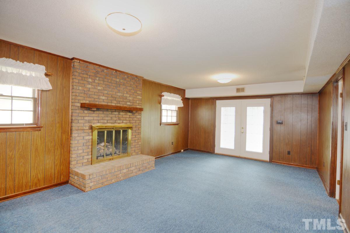 4016 Willow Oak Road Raleigh, NC 27604 - Photo 9 of 21 an empty room with windows and fireplace