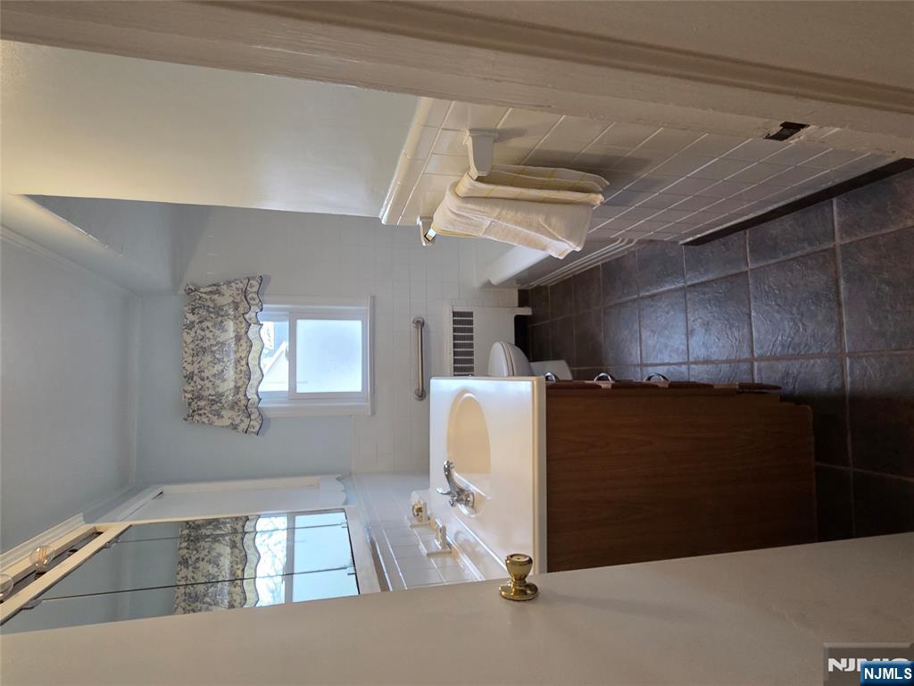 276 Franklin Turnpike Ridgewood, NJ 07450 - Photo 13 of 23 a room with a sink and a mirror