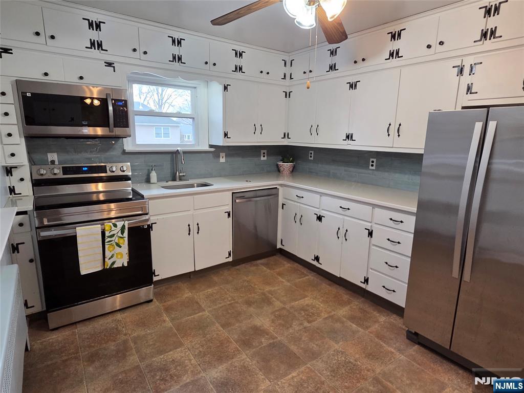 276 Franklin Turnpike Ridgewood, NJ 07450 - Photo 5 of 23 a kitchen with stainless steel appliances granite countertop a stove a sink and a microwave