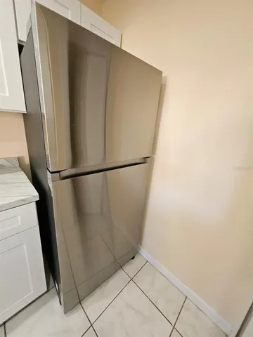 a view of a refrigerator in a kitchen