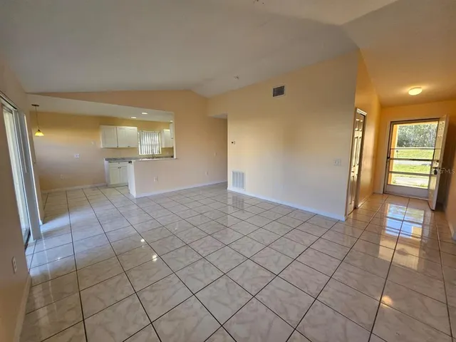 a view of a kitchen with a sink and a refrigerator