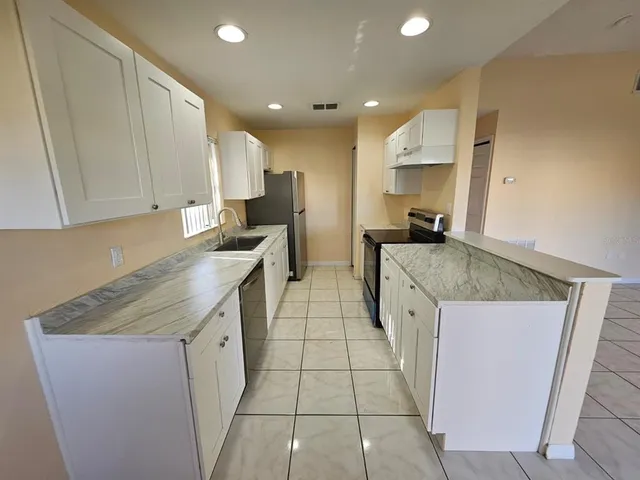 a kitchen with a sink stove and cabinets