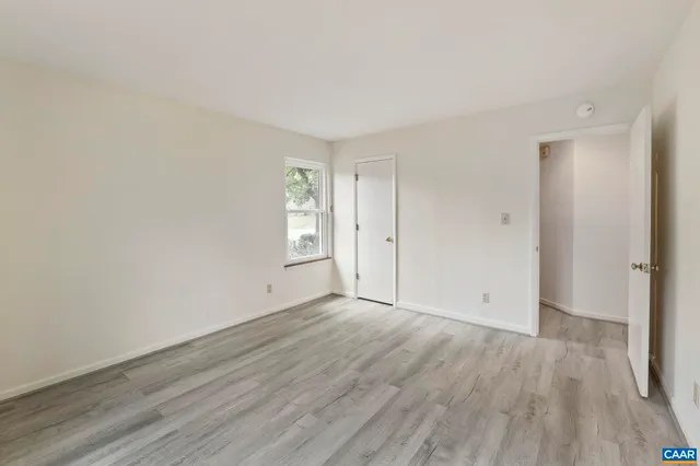 a kitchen with stainless steel appliances white cabinets and a refrigerator