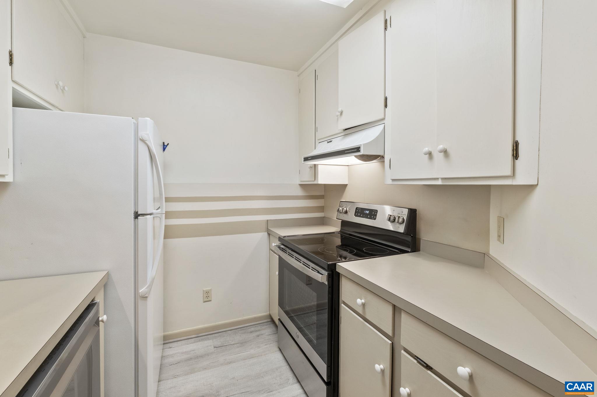 767 Exton Court Charlottesville, VA 22901 - Photo 26 of 34 a kitchen with stainless steel appliances white cabinets and a refrigerator