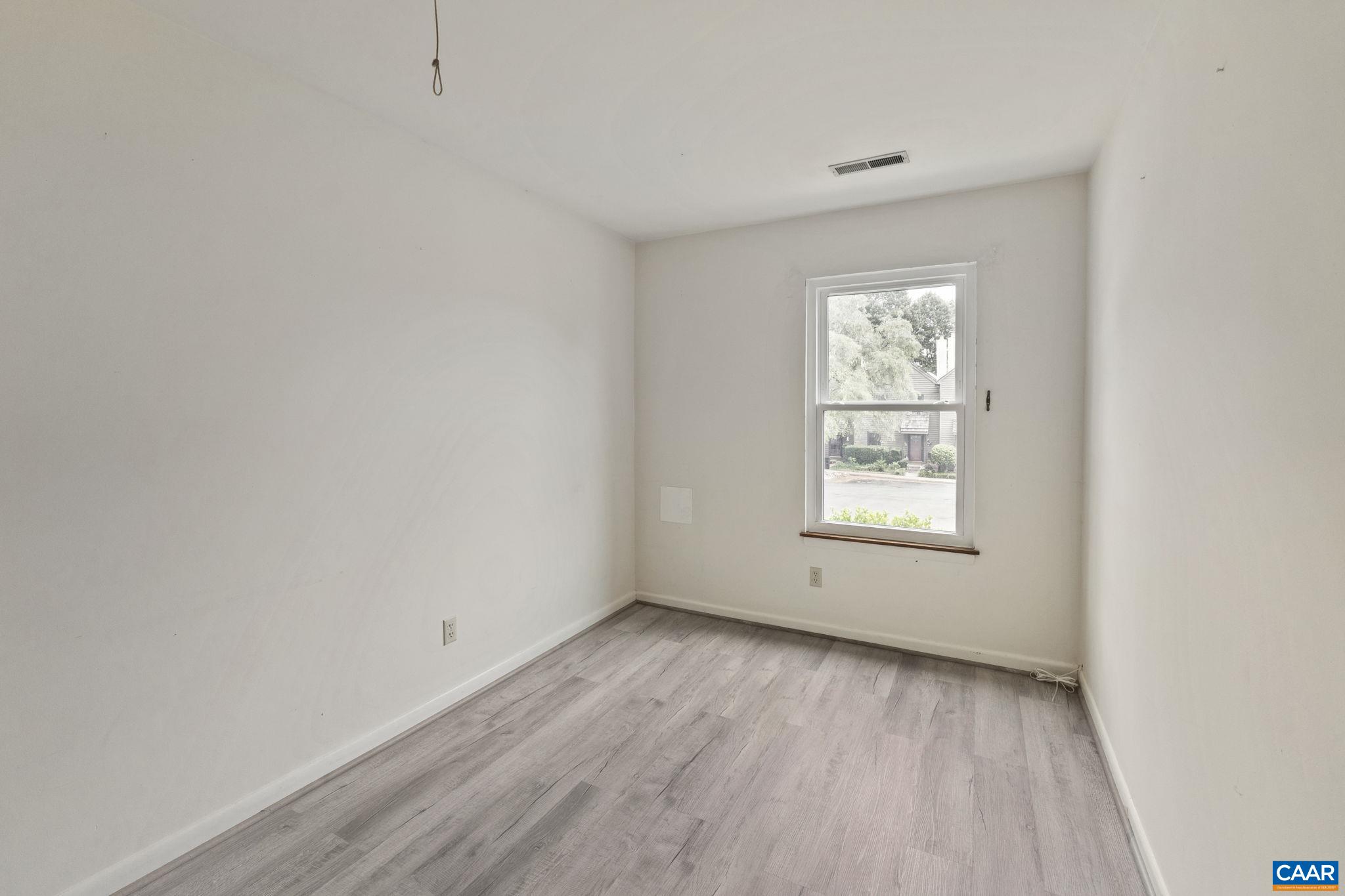767 Exton Court Charlottesville, VA 22901 - Photo 31 of 34 an empty room with wooden floor and windows