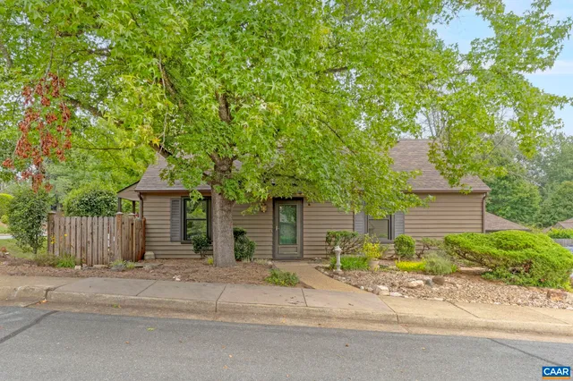 a front view of a house with a garden and garage
