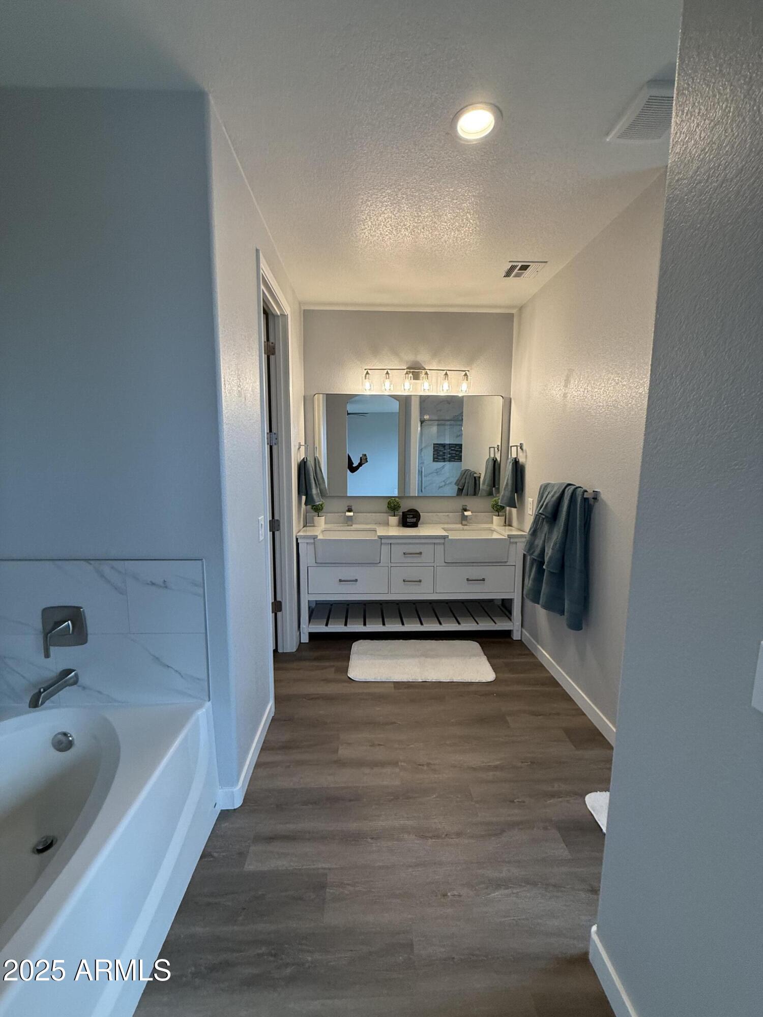 2972 West South Butte Road Queen Creek, AZ 85144 - Photo 12 of 17 a spacious bathroom with a tub double vanity and mirrors