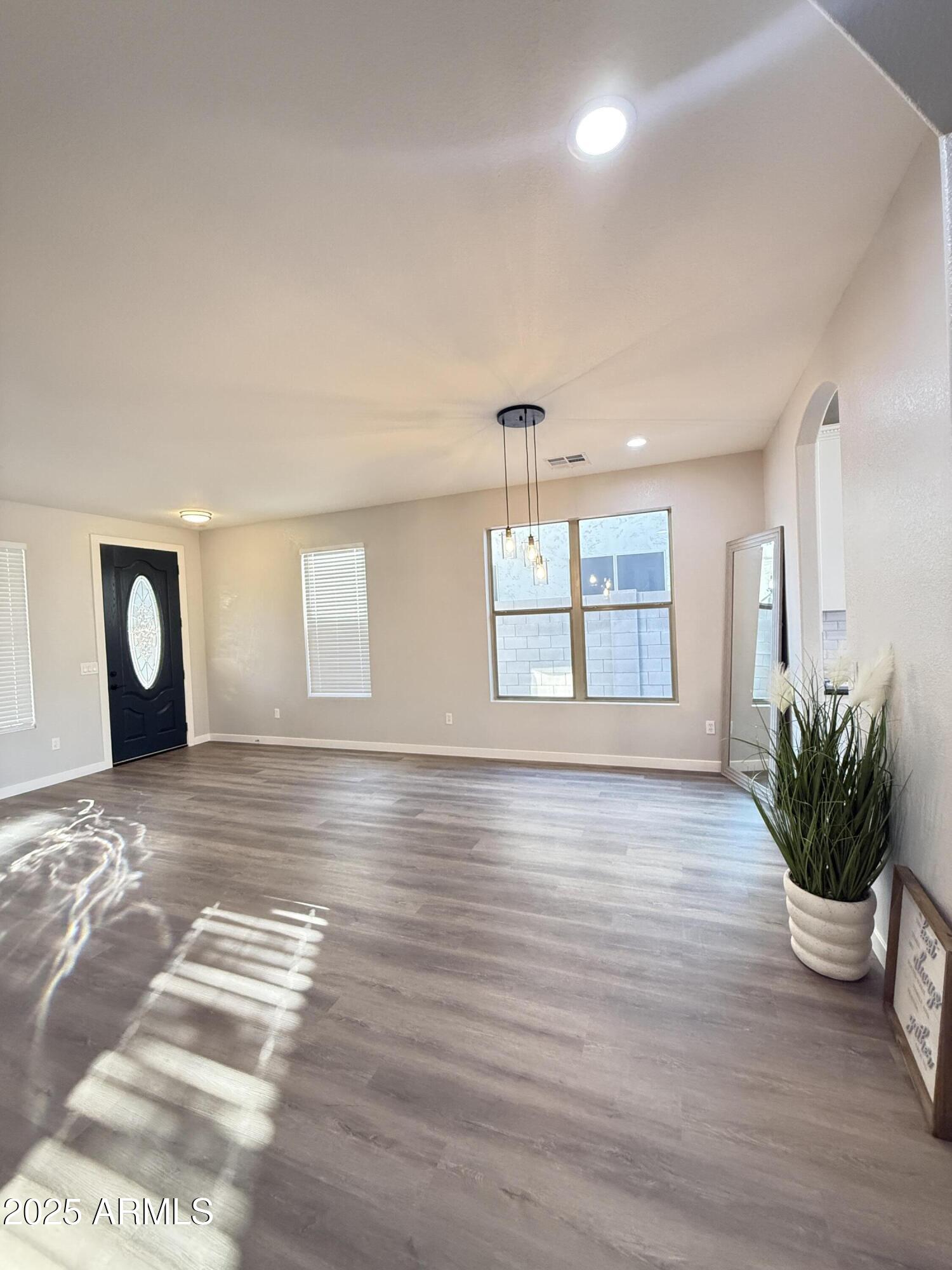 2972 West South Butte Road Queen Creek, AZ 85144 - Photo 2 of 17 a view of an empty room with window and wooden floor