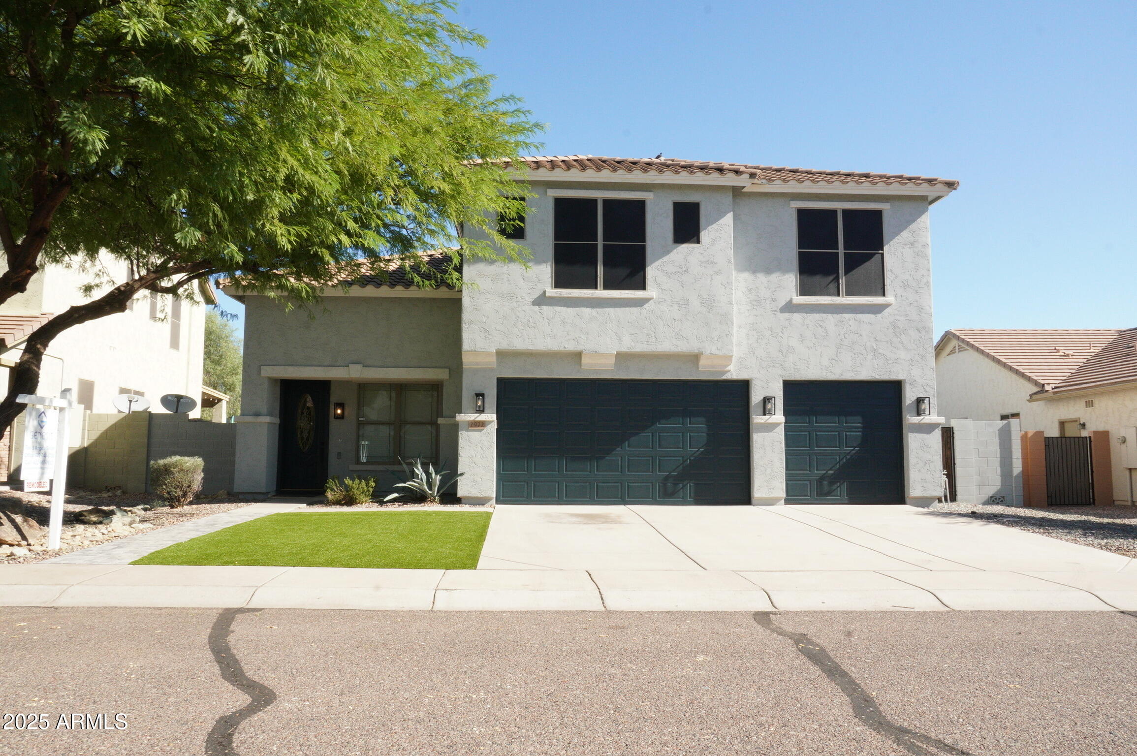 2972 West South Butte Road Queen Creek, AZ 85144 - Photo 4 of 17 a view of a house with a small yard and large tree
