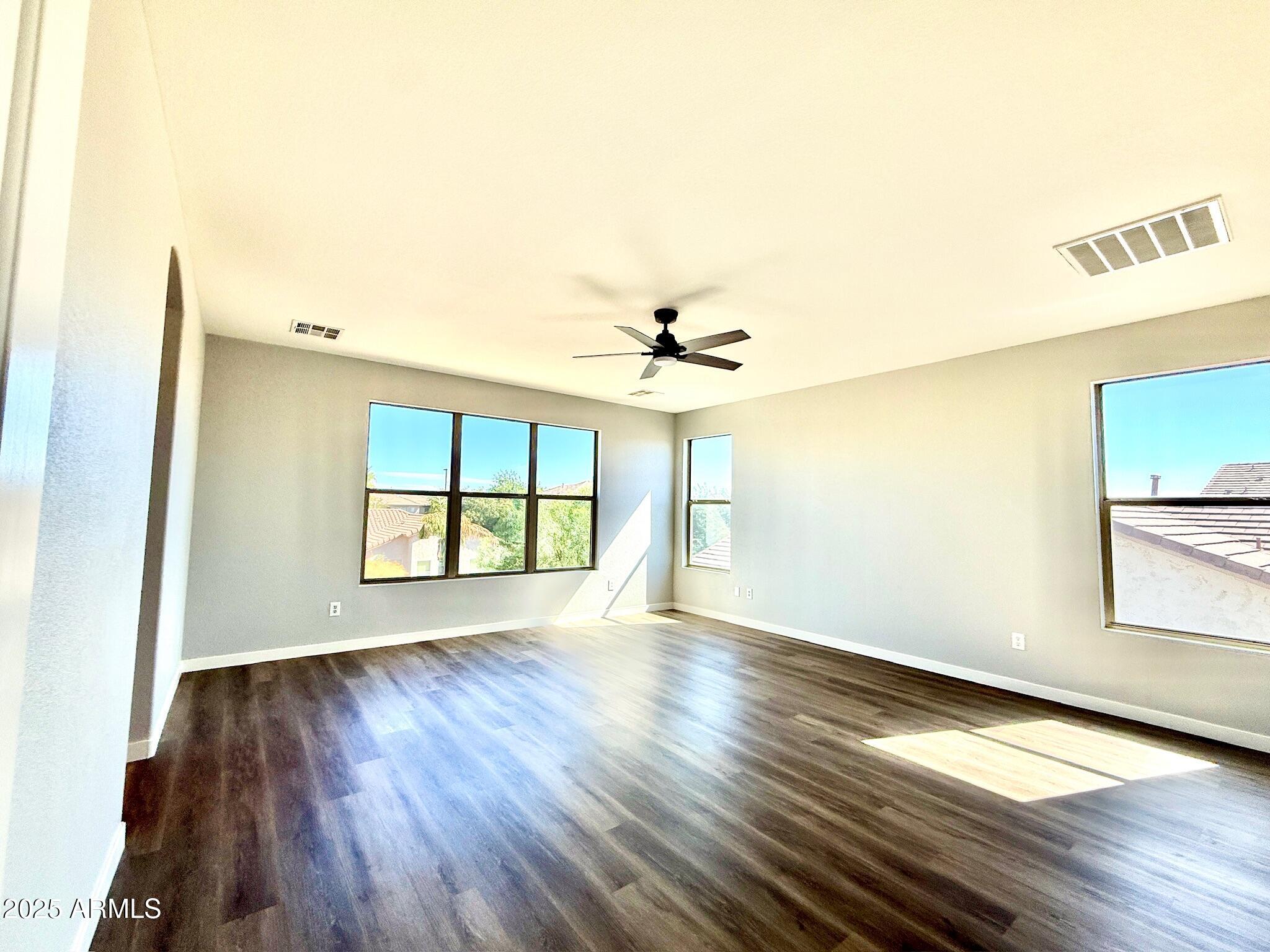 2972 West South Butte Road Queen Creek, AZ 85144 - Photo 10 of 17 a view of an empty room with a window and wooden floor