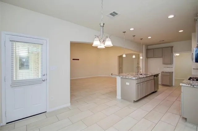 a large kitchen with a large counter top cabinets and appliances