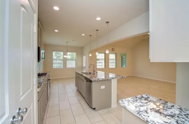 a kitchen with stainless steel appliances granite countertop a sink and cabinets