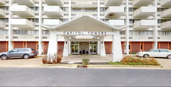 a view of a building with car parked