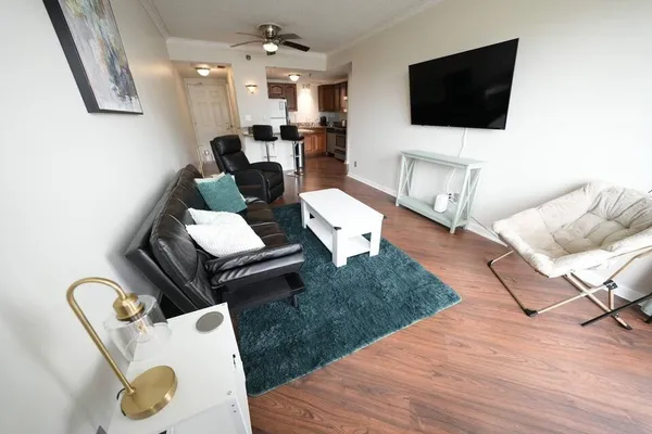a living room with furniture and a flat screen tv