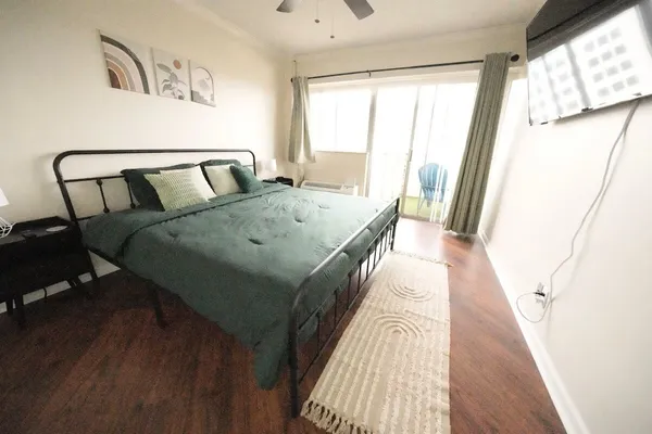 a bed sitting in a bedroom next to a window