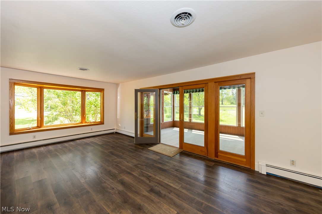 7969 Dines Road Novelty, OH 44072 - Photo 4 of 48 Spacious Living room with dark wood-finish flooring, bay window and French doors leading to Sun room