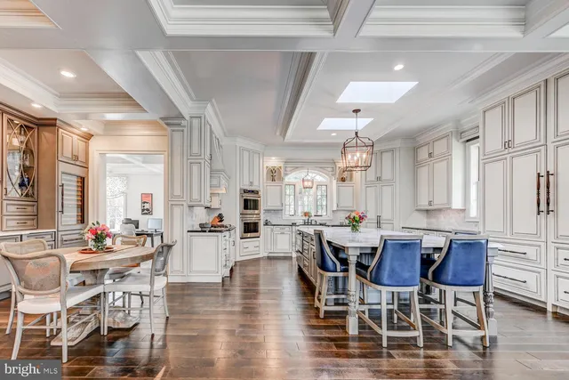 a kitchen with stainless steel appliances kitchen island granite countertop a stove and cabinets