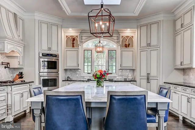a kitchen with cabinets and wooden floor