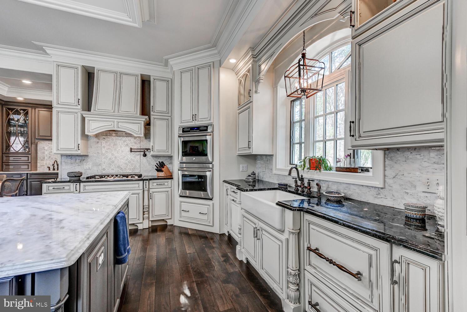 1848 Circle Road Towson, MD 21204 - Photo 24 of 69 a kitchen with stainless steel appliances granite countertop a stove a sink dishwasher and white cabinets with wooden floor