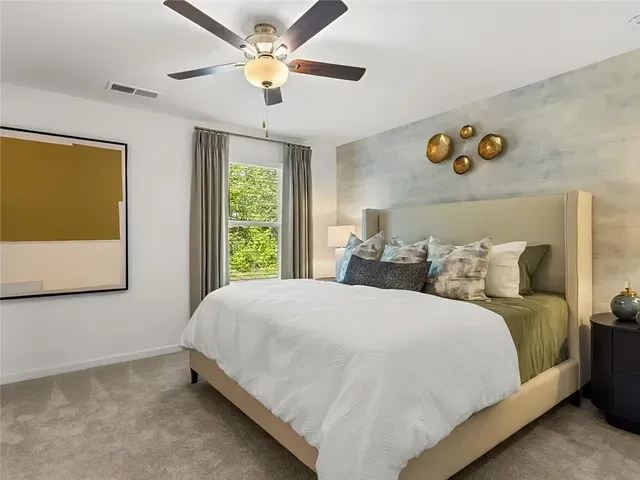 a bedroom with a large bed and a window