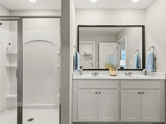 a bathroom with a double vanity sink and a mirror