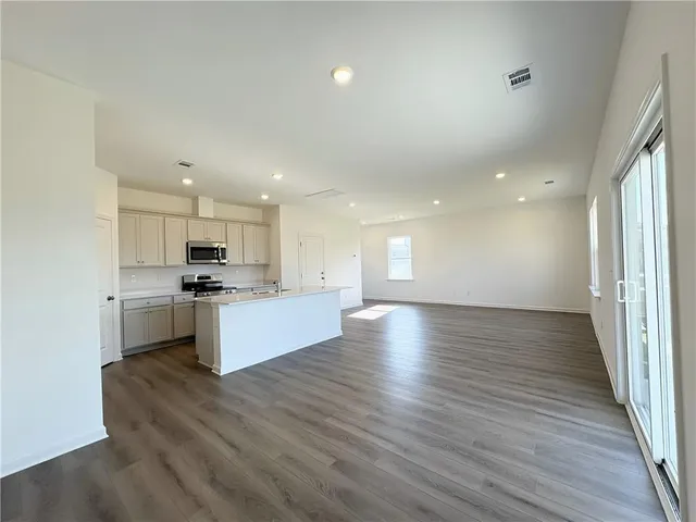 a view of kitchen with wooden floor and electronic appliances