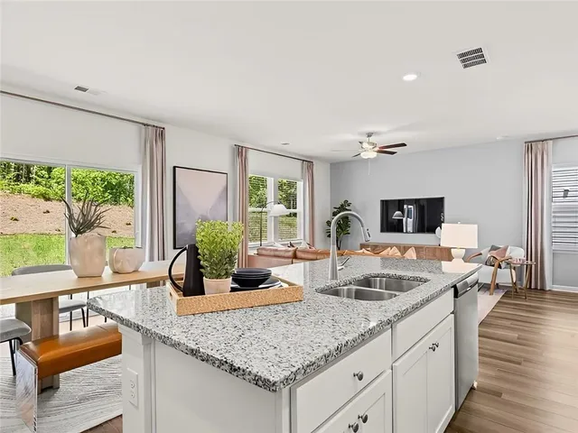 a living room with granite countertop kitchen island furniture and a large window