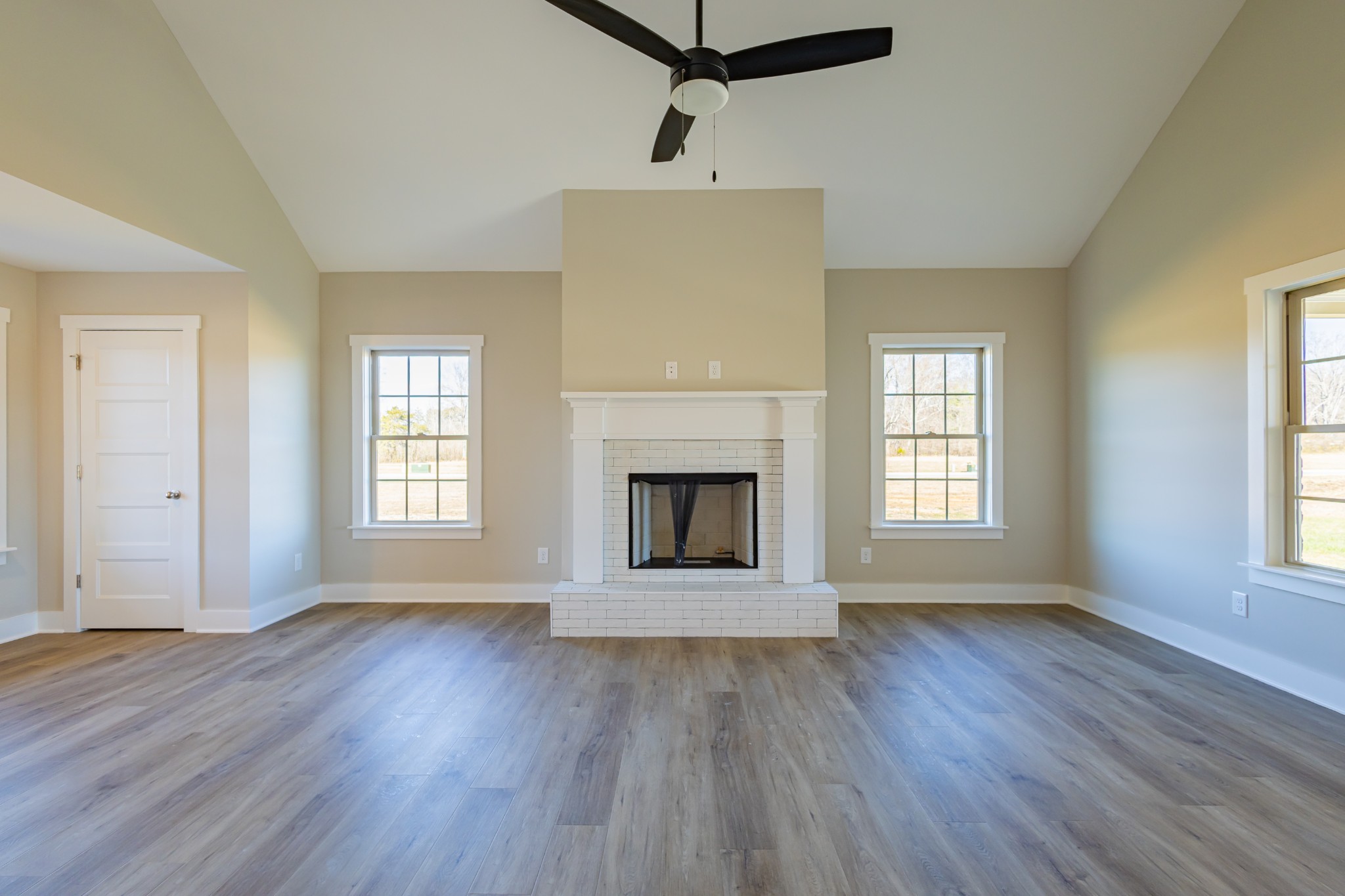 31 Brooklyn Avenue Manchester, TN 37355 - Photo 17 of 66 an empty room with wooden floor a fireplace and windows