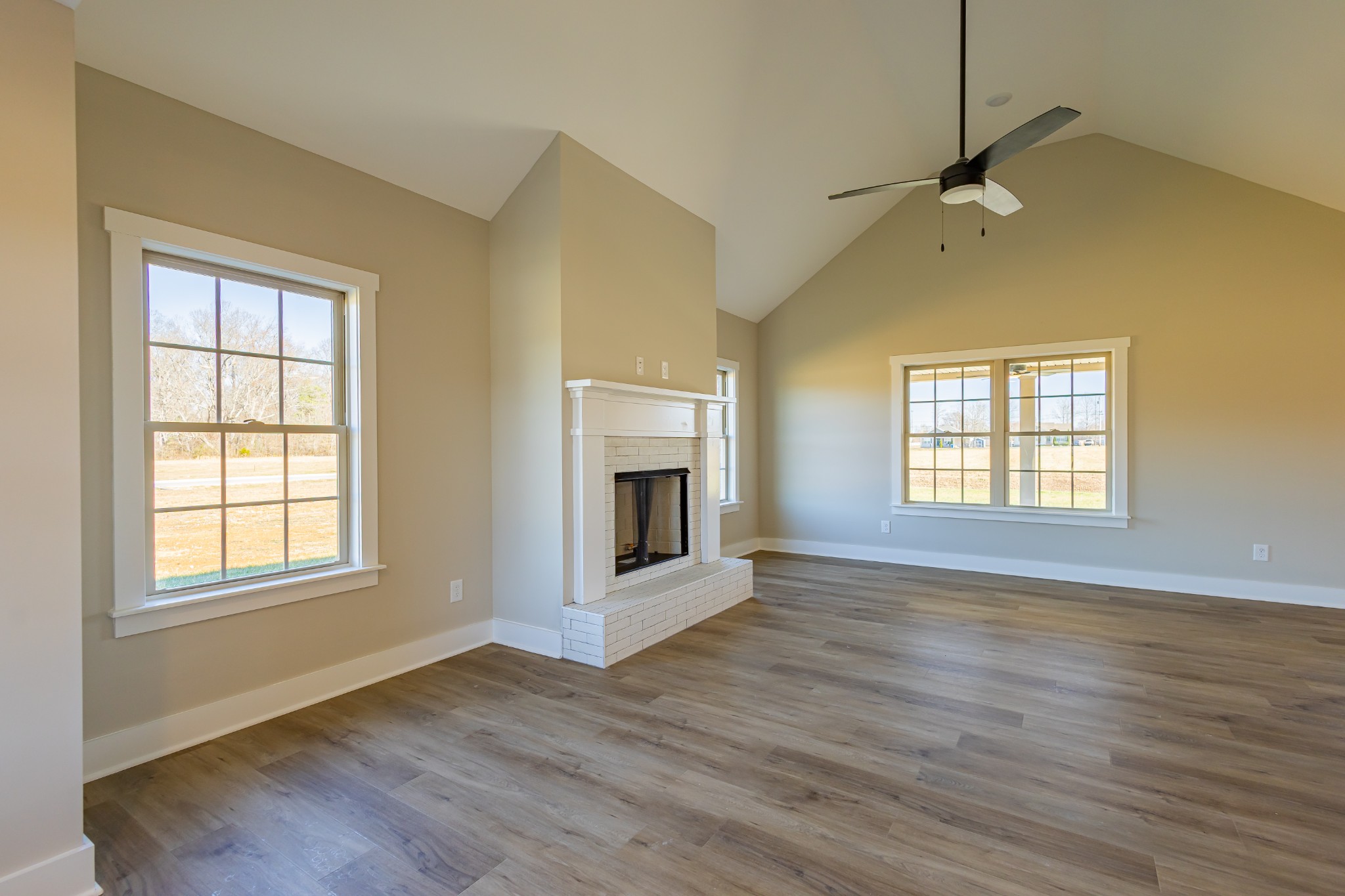 31 Brooklyn Avenue Manchester, TN 37355 - Photo 18 of 66 an empty room with wooden floor fireplace and windows