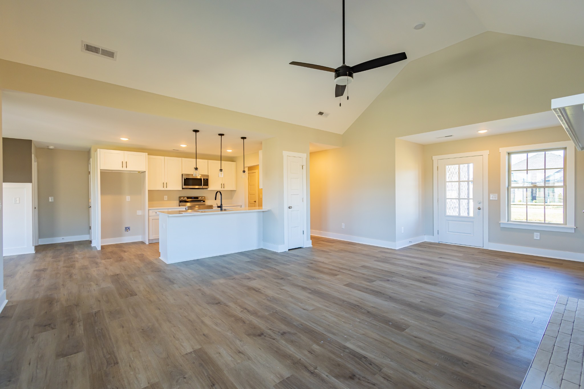 31 Brooklyn Avenue Manchester, TN 37355 - Photo 19 of 66 a view of a kitchen with a refrigerator wooden floor and a window