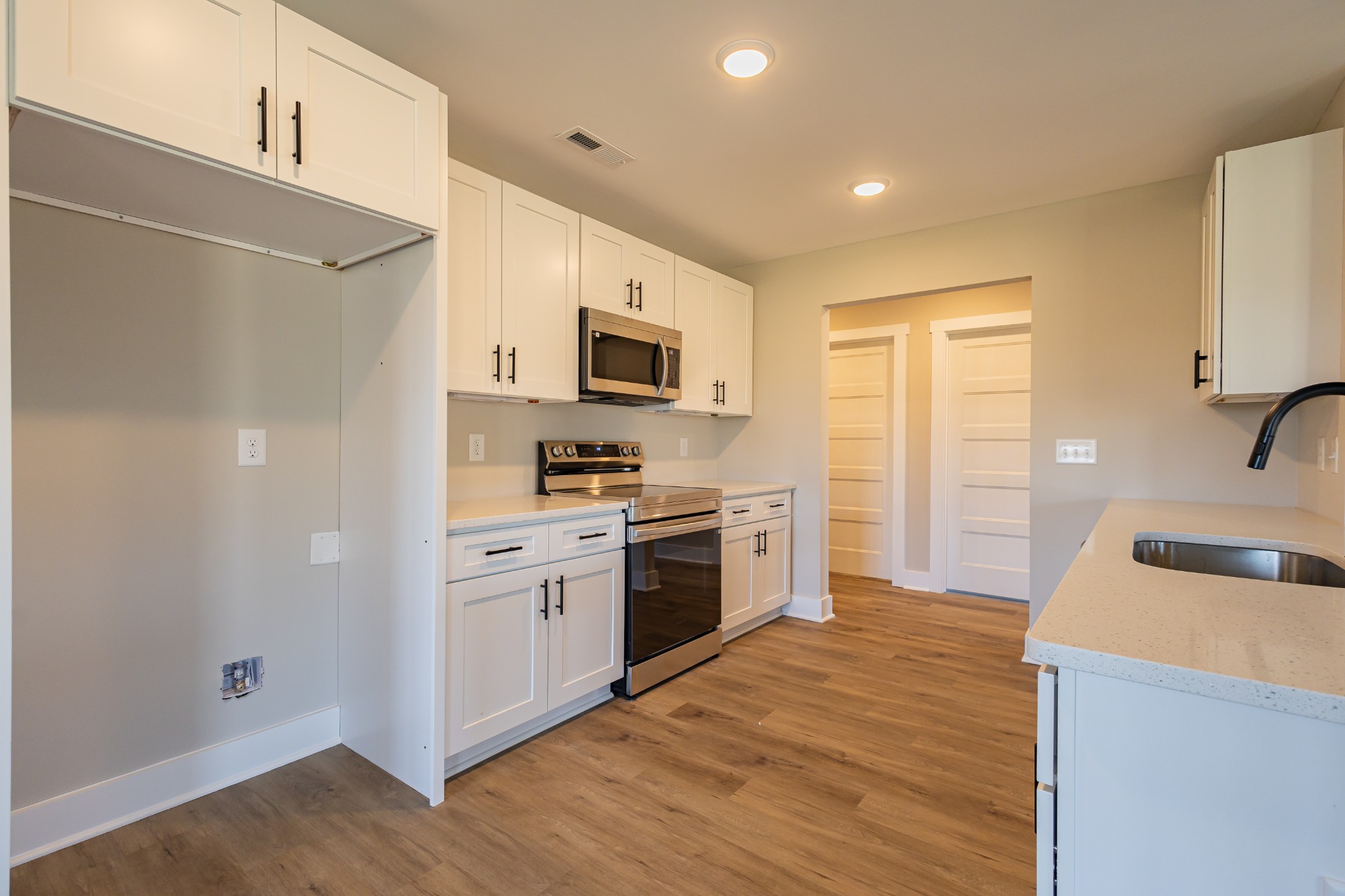 31 Brooklyn Avenue Manchester, TN 37355 - Photo 25 of 66 a kitchen with a sink a stove and refrigerator