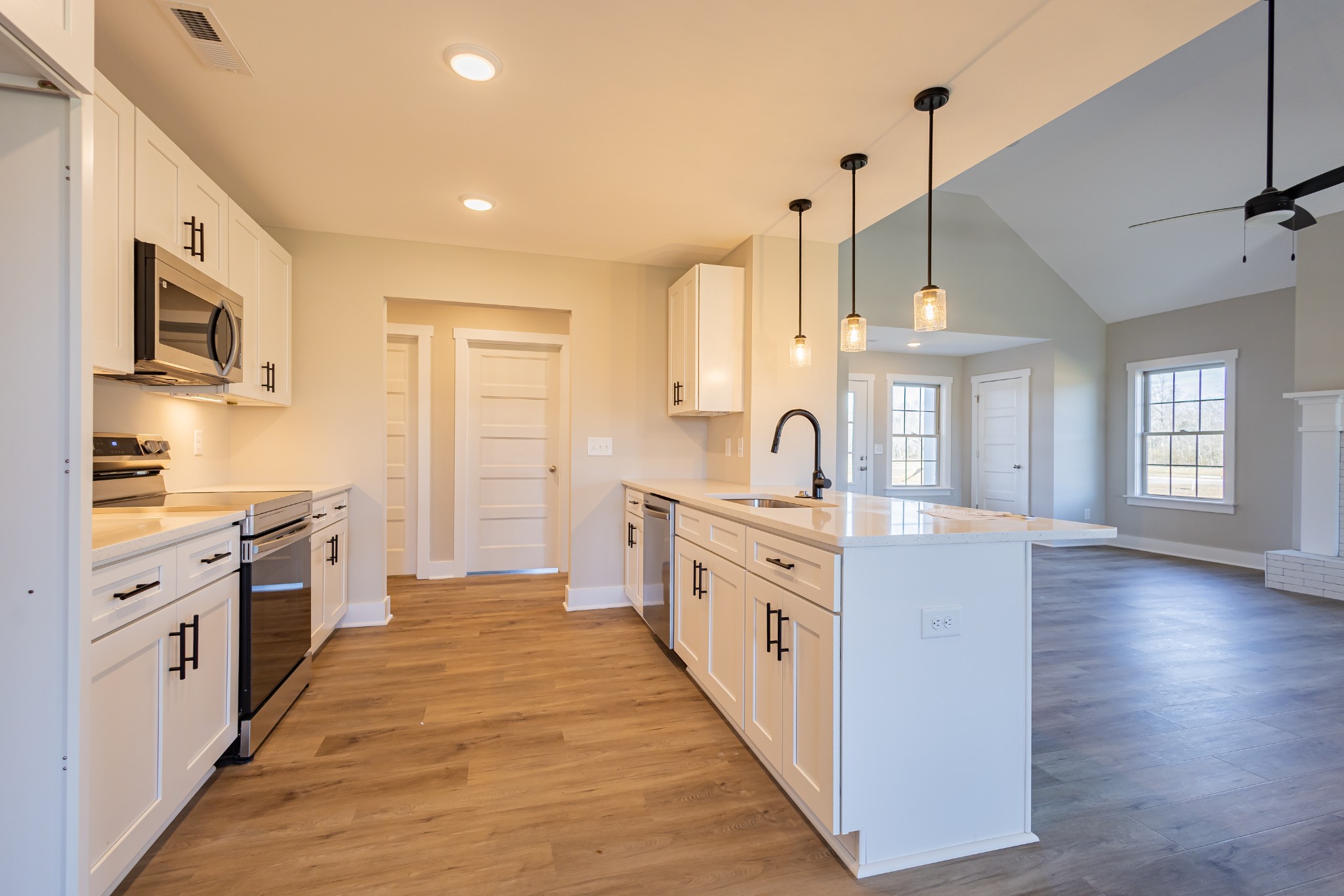 31 Brooklyn Avenue Manchester, TN 37355 - Photo 26 of 66 a large kitchen with stainless steel appliances kitchen island granite countertop a sink and dishwasher a stove with wooden floor
