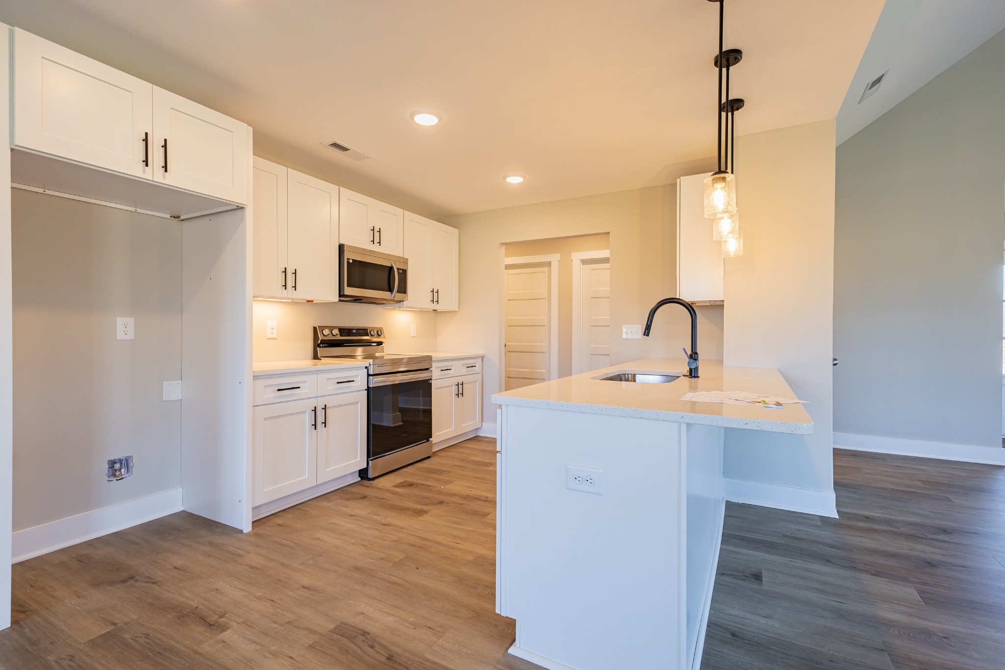 31 Brooklyn Avenue Manchester, TN 37355 - Photo 30 of 66 a kitchen with a sink stainless steel appliances and wooden floor
