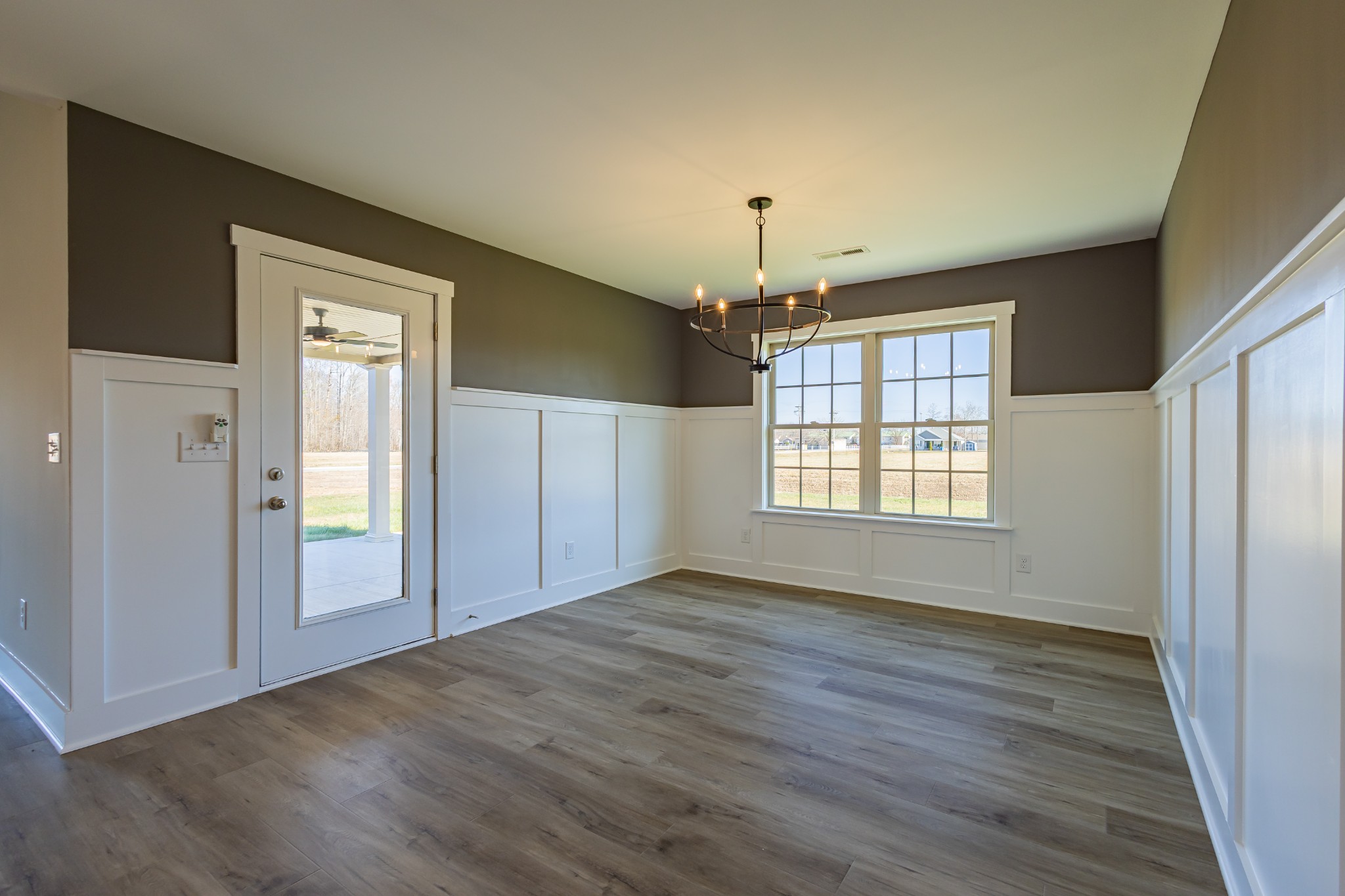 31 Brooklyn Avenue Manchester, TN 37355 - Photo 31 of 66 an empty room with wooden floor chandelier and windows