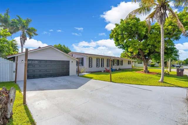 a view of pool house with swimming pool and yard