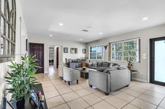 a living room with furniture and a potted plant