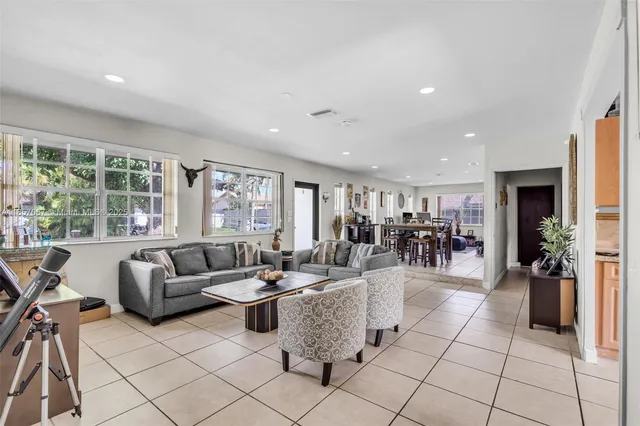 a living room with furniture and large windows